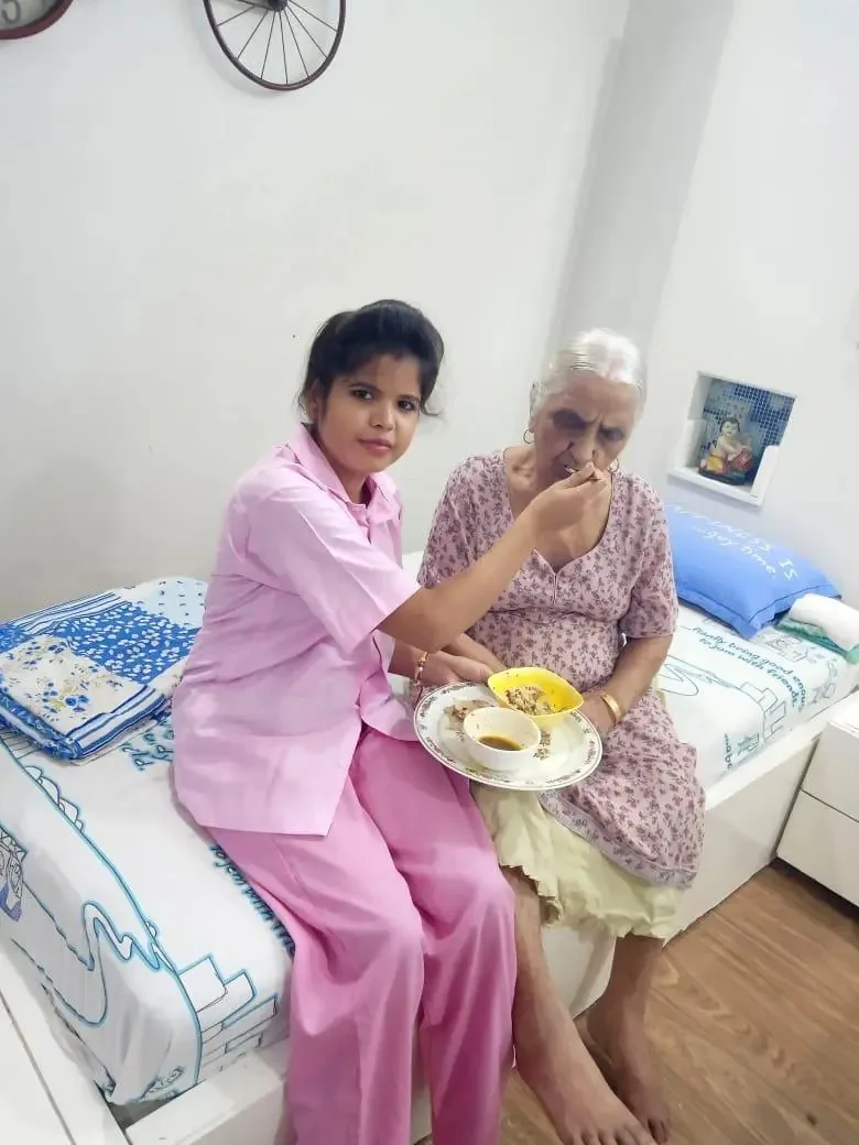 Elder-care professional with a senior at home